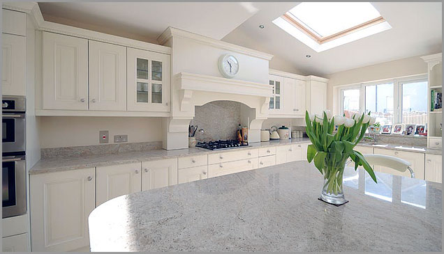 spacious room glows with the white granite countertops